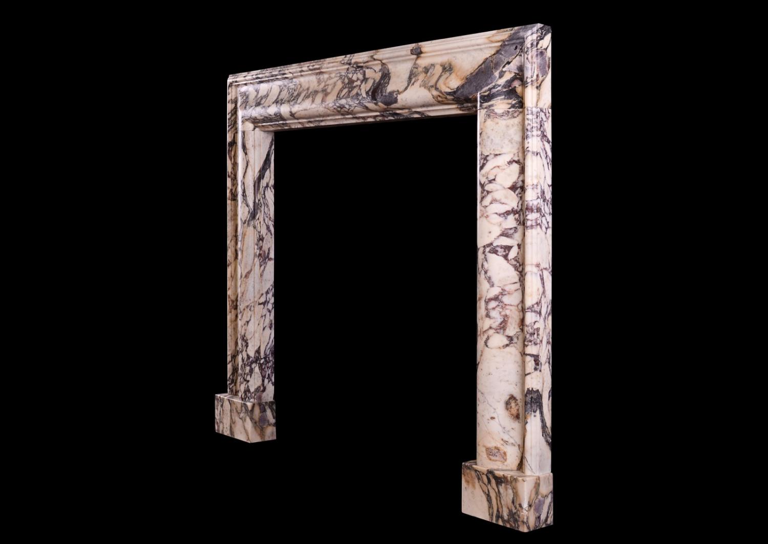 A Breche Violette marble bolection fireplace