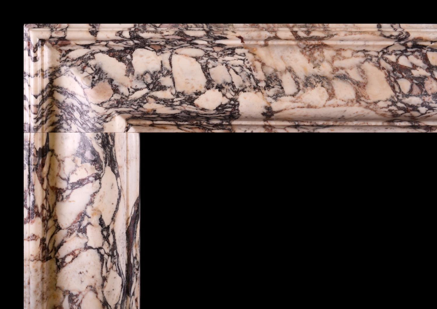 A Breche Violette marble bolection fireplace