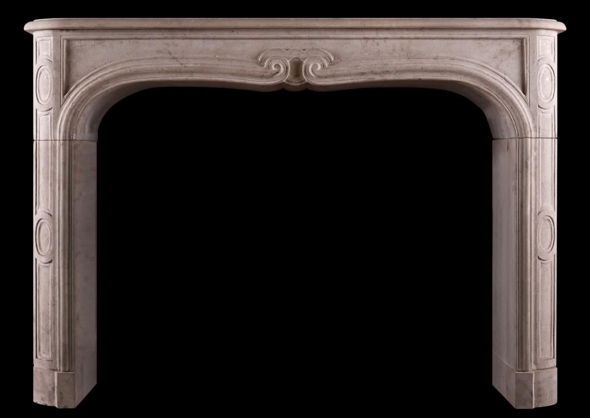 A French limestone transitional Louis XIV/XV fireplace