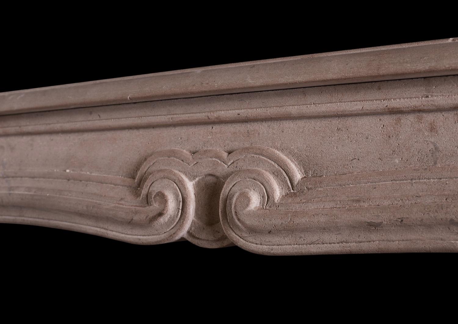 A French limestone transitional Louis XIV/XV fireplace