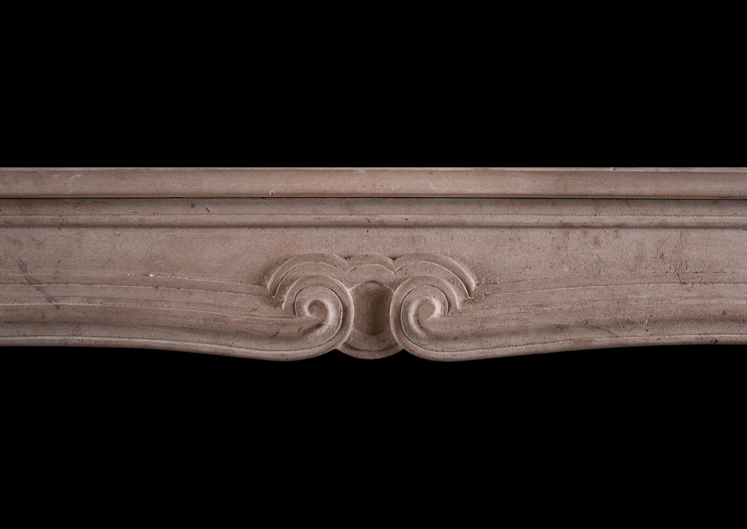 A French limestone transitional Louis XIV/XV fireplace