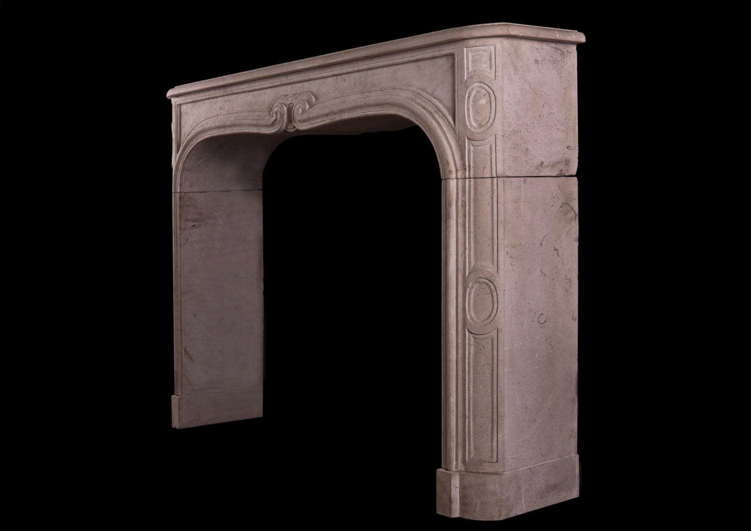 A French limestone transitional Louis XIV/XV fireplace