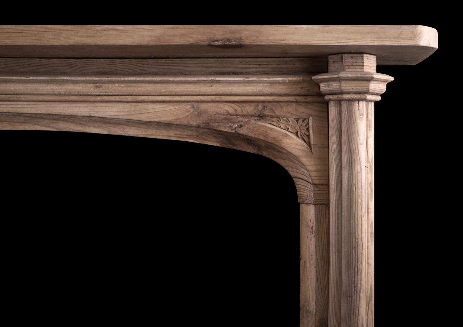 An English pine fireplace in the Gothic manner