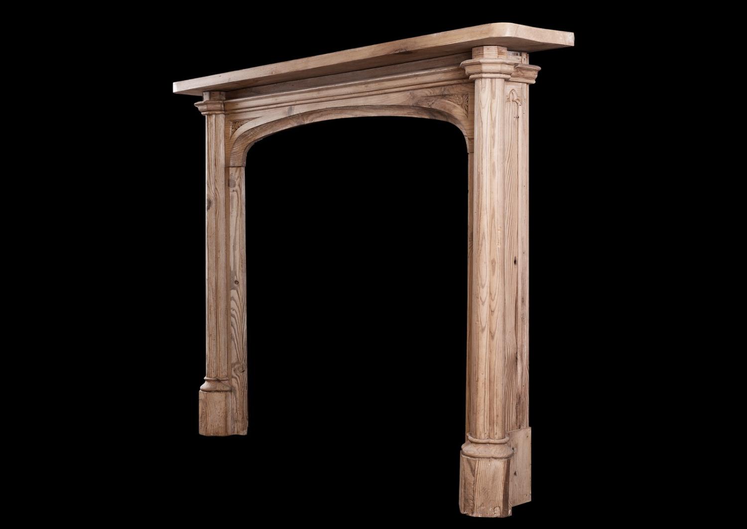 An English pine fireplace in the Gothic manner