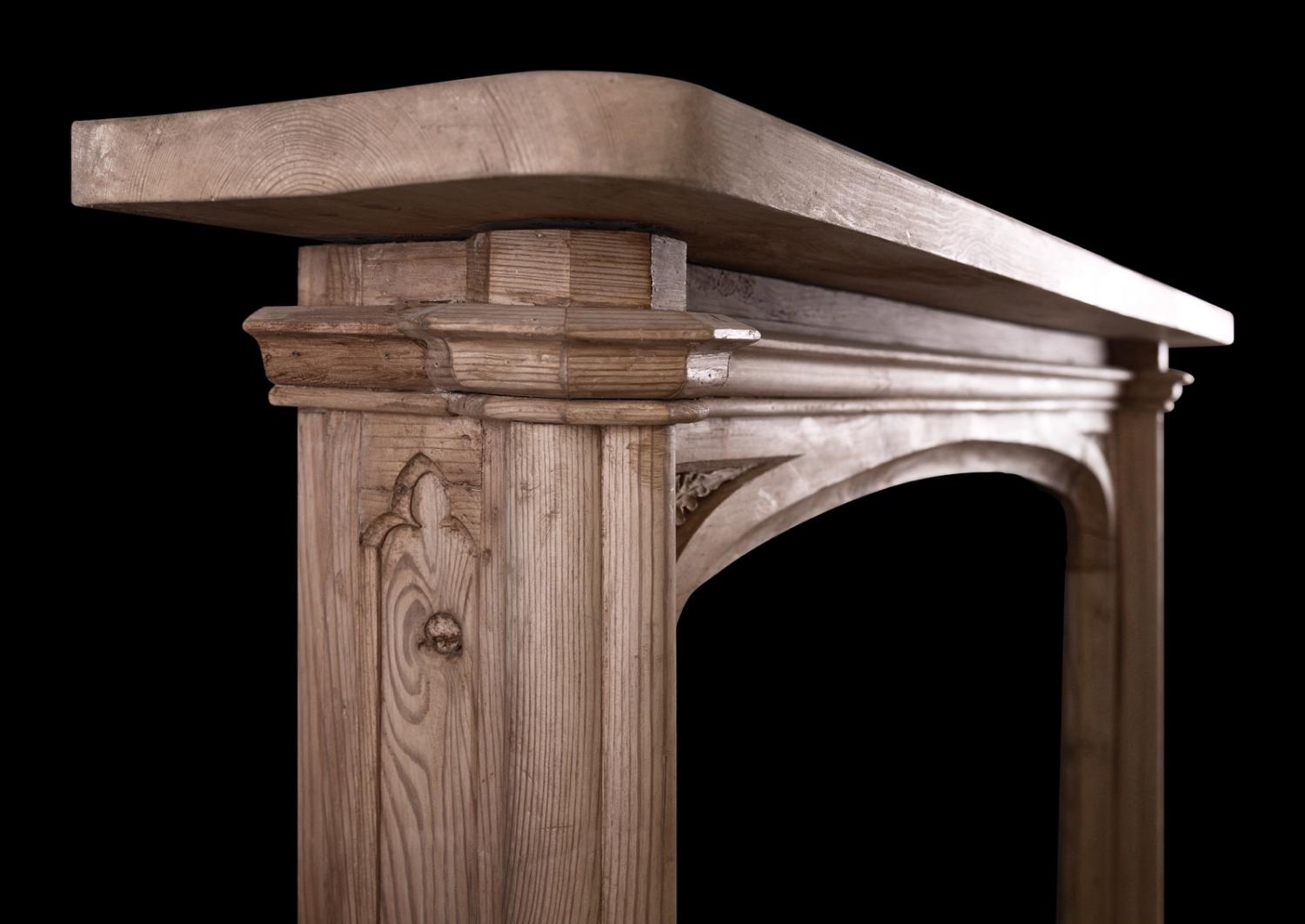 An English pine fireplace in the Gothic manner