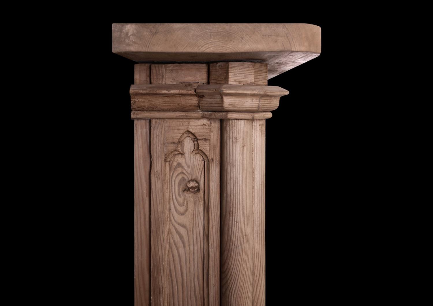 An English pine fireplace in the Gothic manner