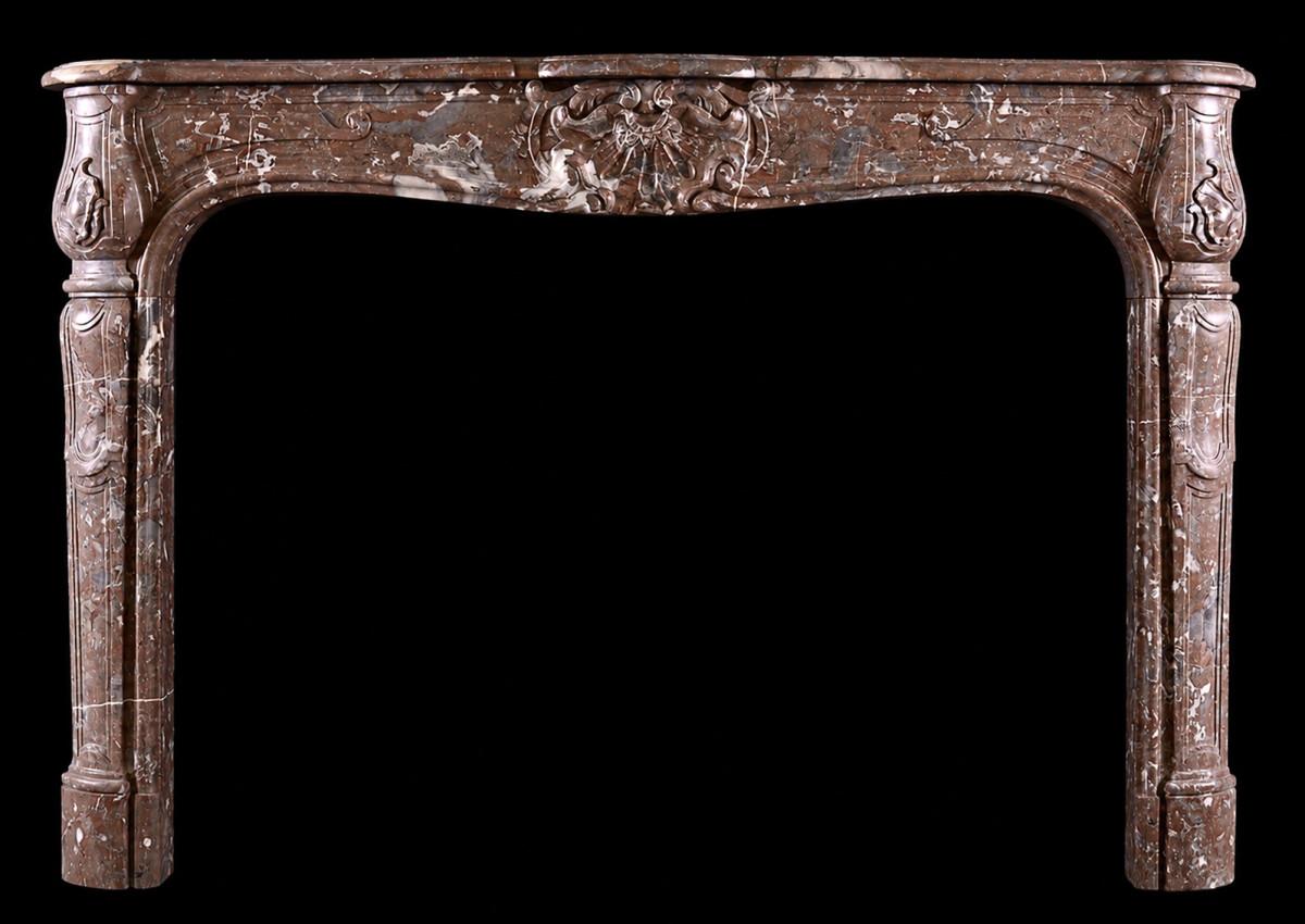 A period French marble fireplace in Languedoc marble