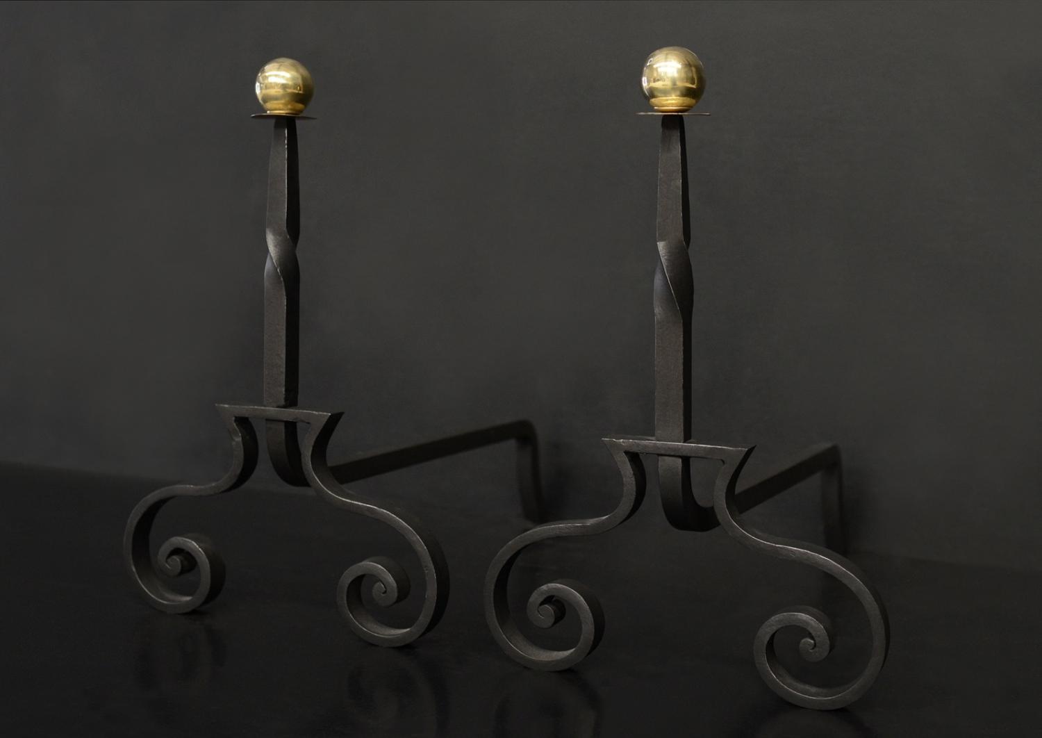 A pair of wrought iron firedogs