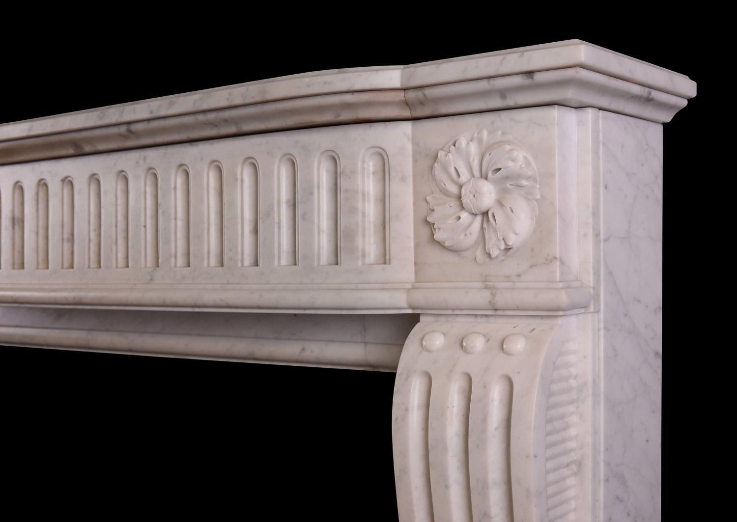A Louis XVI style fireplace in a light Carrara marble