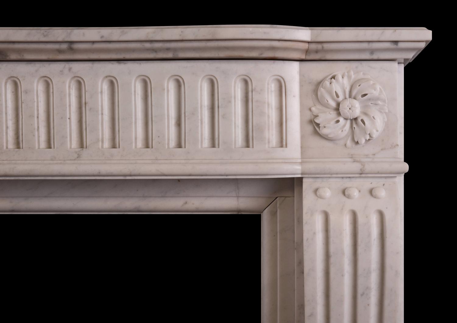 A Louis XVI style fireplace in a light Carrara marble