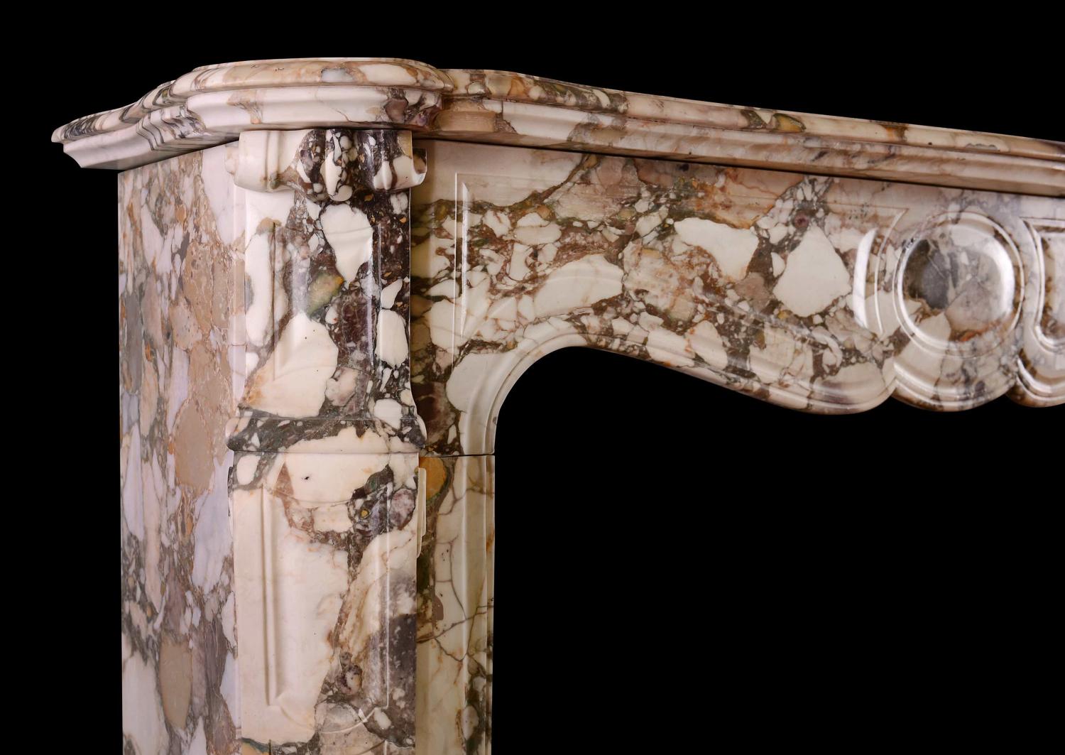 A French Louis XV style fireplace in Brèche de Bénou marble
