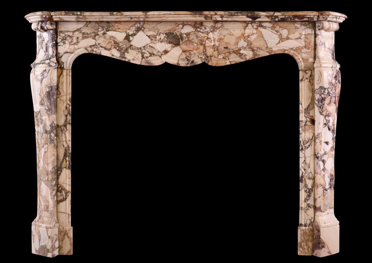 A French Louis XV style fireplace in Brèche de Bénou marble