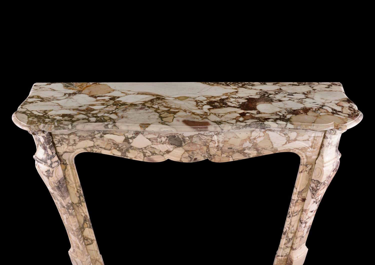 A French Louis XV style fireplace in Brèche de Bénou marble