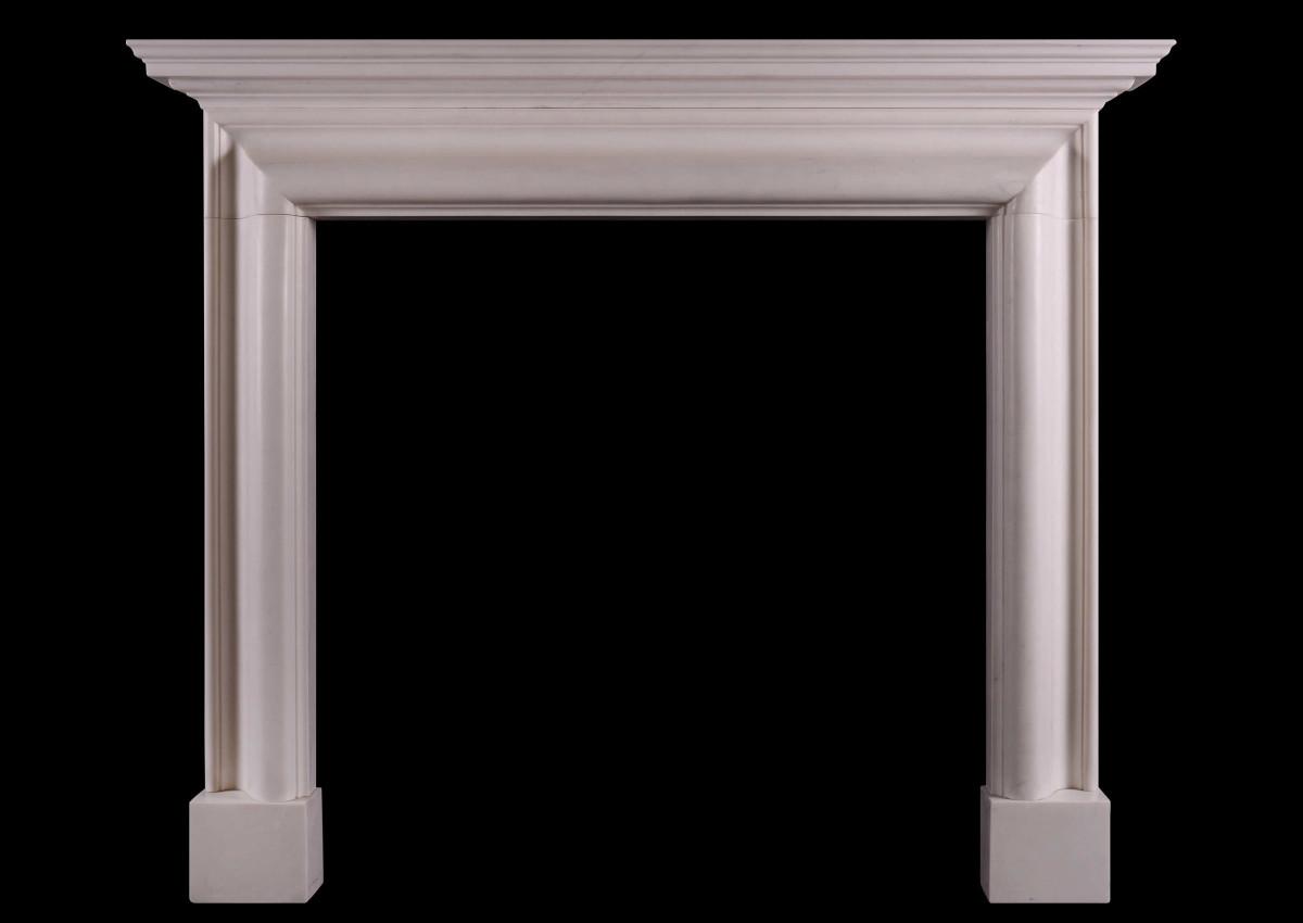 An architectural white marble fireplace