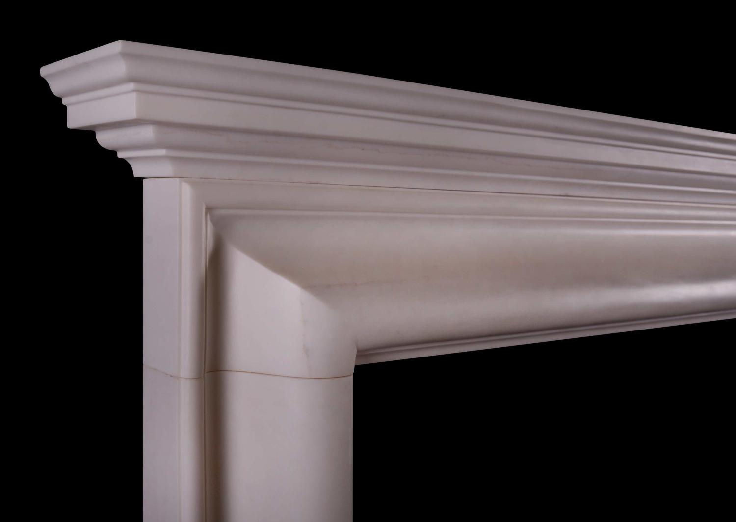 An architectural white marble fireplace